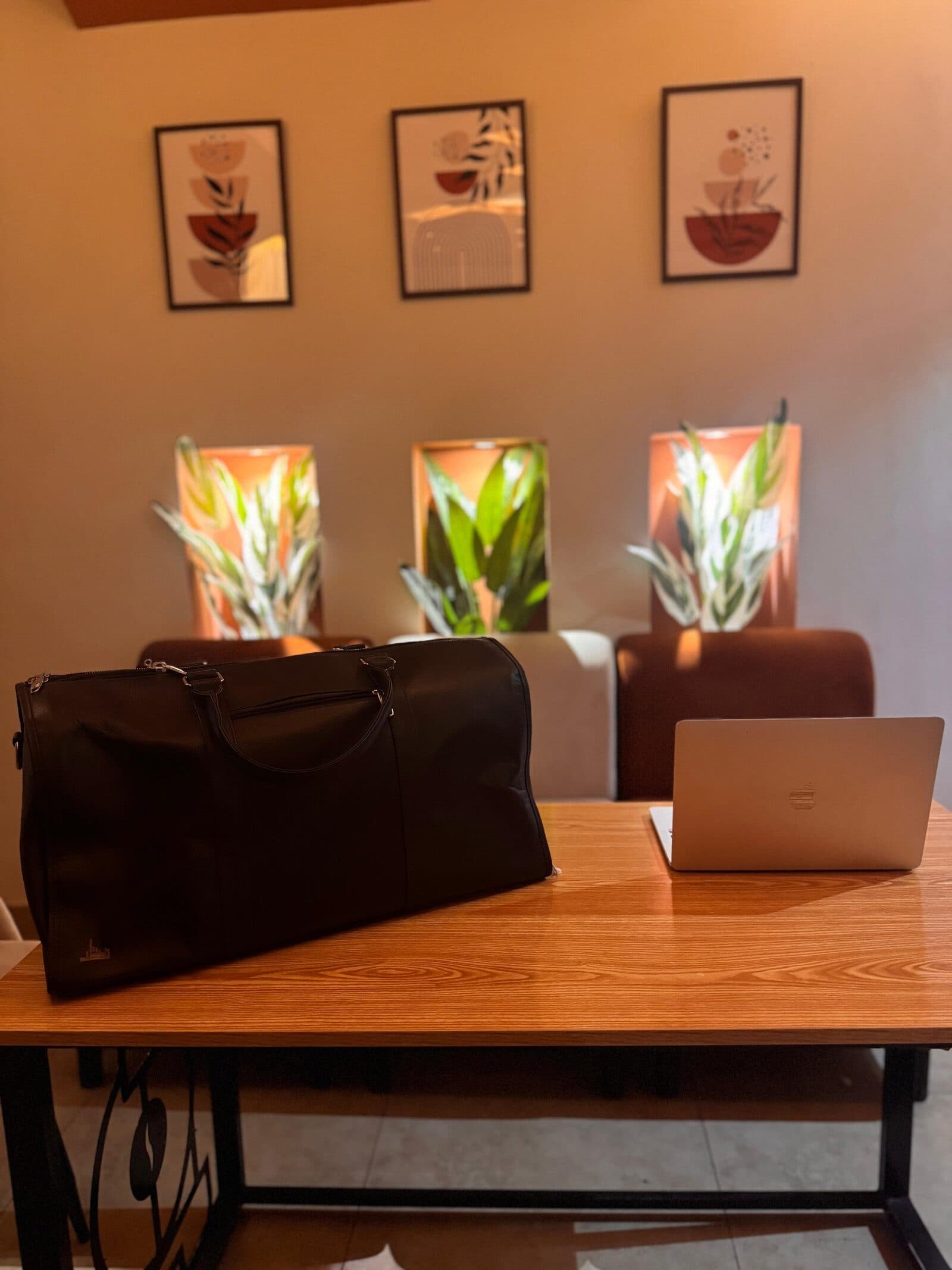 Dastaar leather bag beside a laptop
