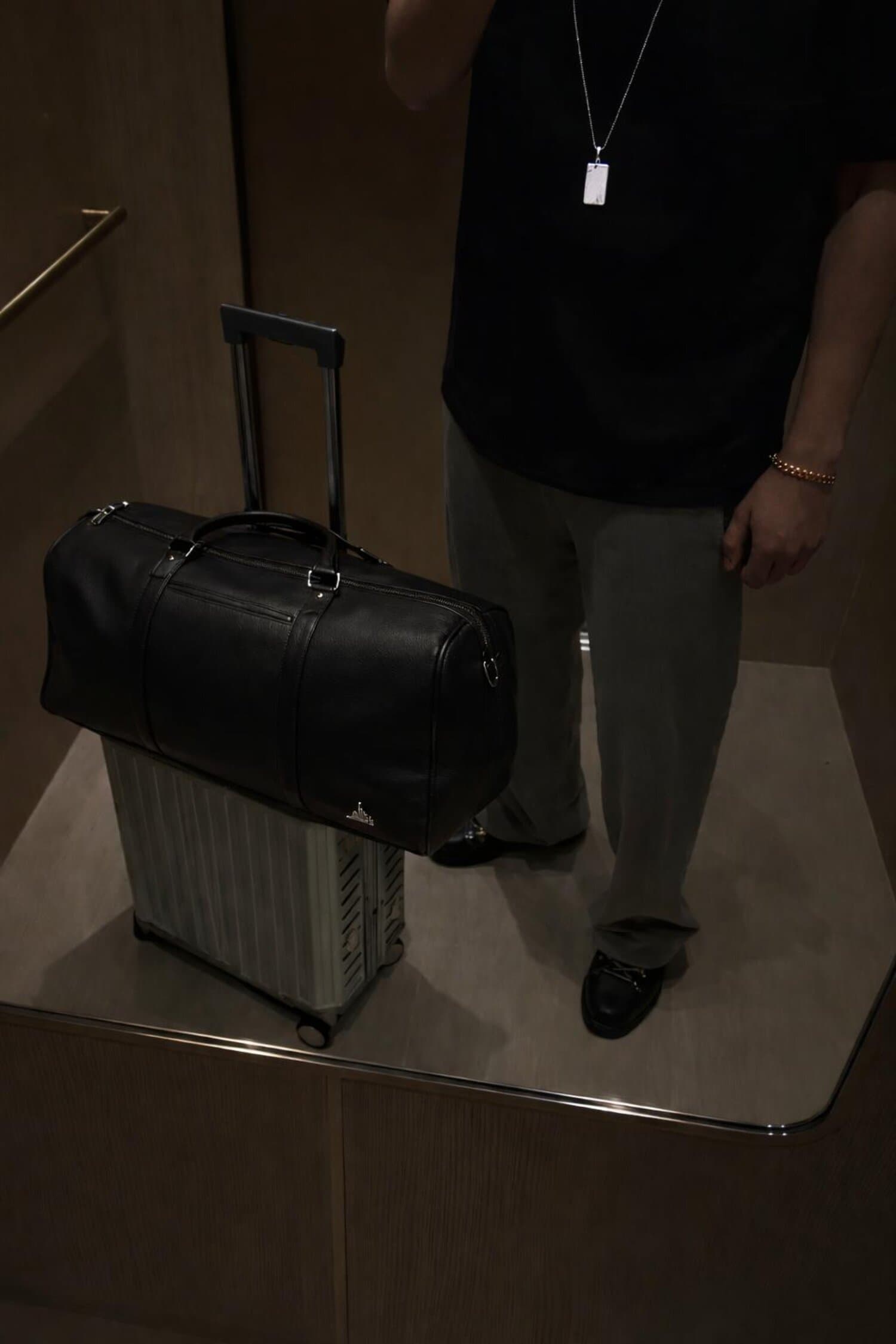 Dastaar leather holdall on a suitcase